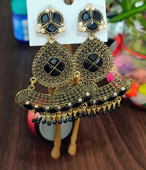 Black drop earrings with a floral design, adorned with sparkling rhinestones and golden accents