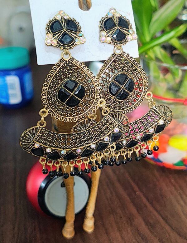 Black drop earrings with a floral design, adorned with sparkling rhinestones and golden accents