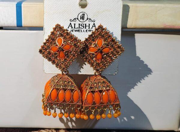 Orange jhumka earrings with a floral design and sparkling rhinestones.