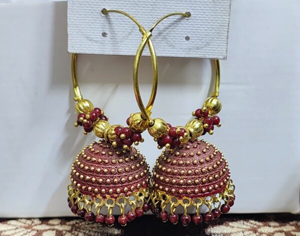 Maroon hoop earrings with a jhumka design and beaded accents.