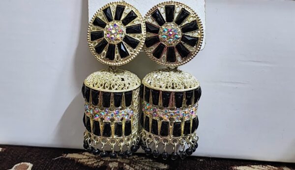 Black jhumka earrings with a floral design, adorned with sparkling rhinestones and golden accents.