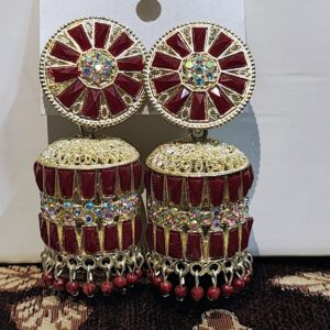 Red jhumka earrings with a floral design, adorned with sparkling rhinestones and gold accents