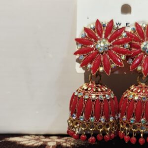 Red jhumka earrings with floral design and sparkling rhinestones