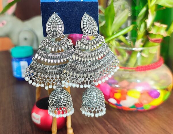 Oxidized silver jhumka earrings with pearl accents and intricate detailing.