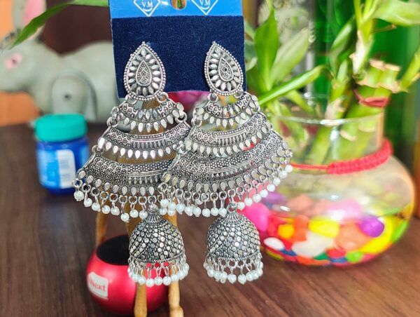 Oxidized silver jhumka earrings with pearl accents and intricate detailing.