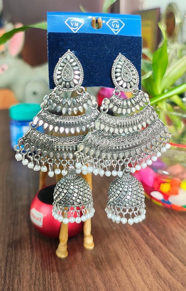 Oxidized silver jhumka earrings with pearl accents and intricate detailing.