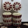 Red jhumka earrings with a floral design, adorned with sparkling rhinestones and gold accents