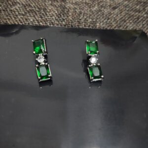 Green emerald stud earrings with cubic zirconia accents.