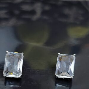 White emerald cut stud earrings with sparkling accents.