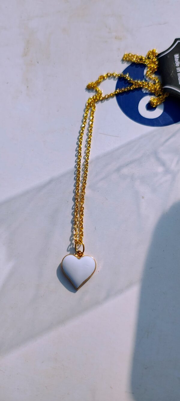 A white heart pendant necklace with a gold-toned chain