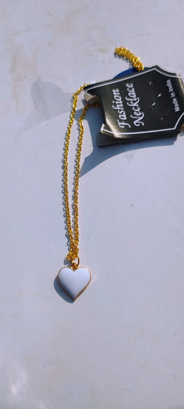 A white heart pendant necklace with a gold-toned chain