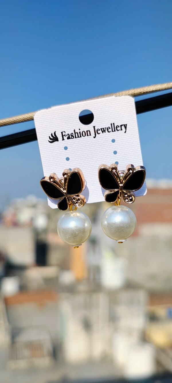 Black butterfly earrings with pearl accents.