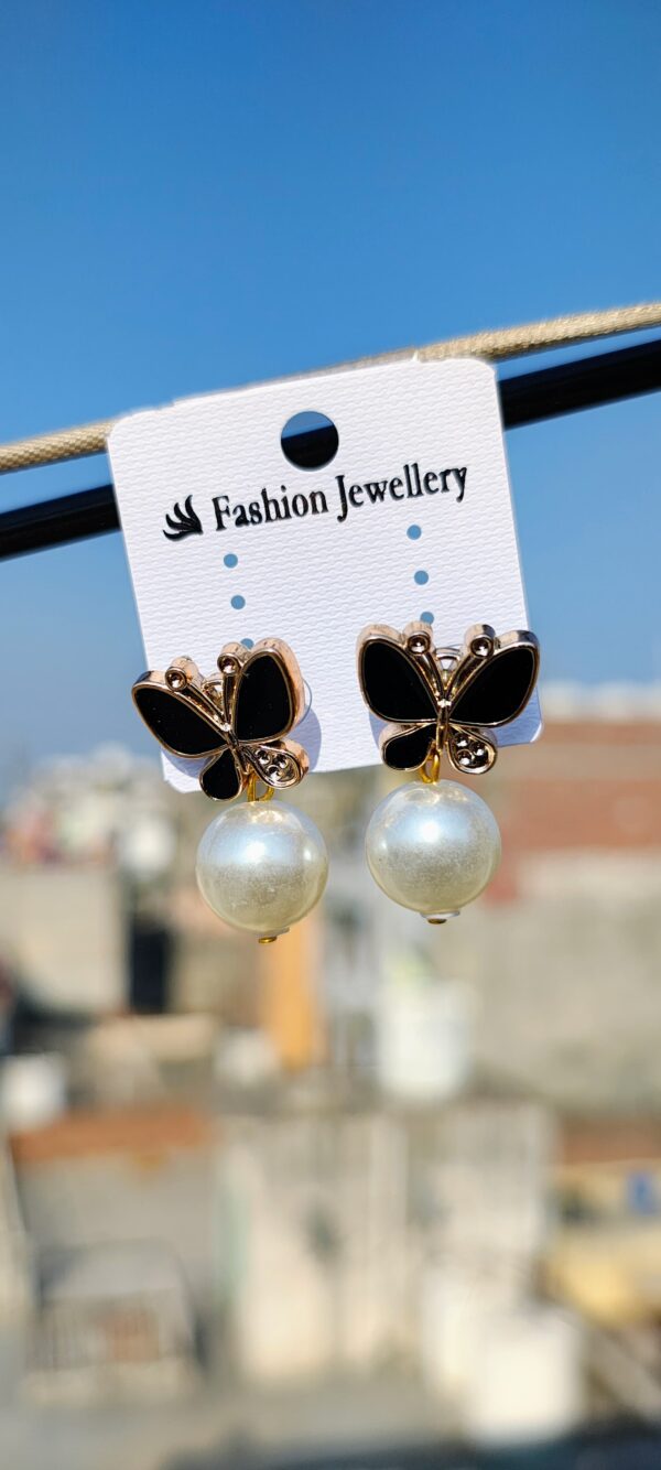 Black butterfly earrings with pearl accents.