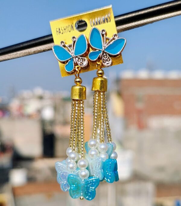 Blue butterfly earrings with tassels and pearl accents.