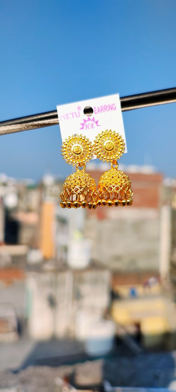 Gold-toned jhumka earrings with intricate designs.