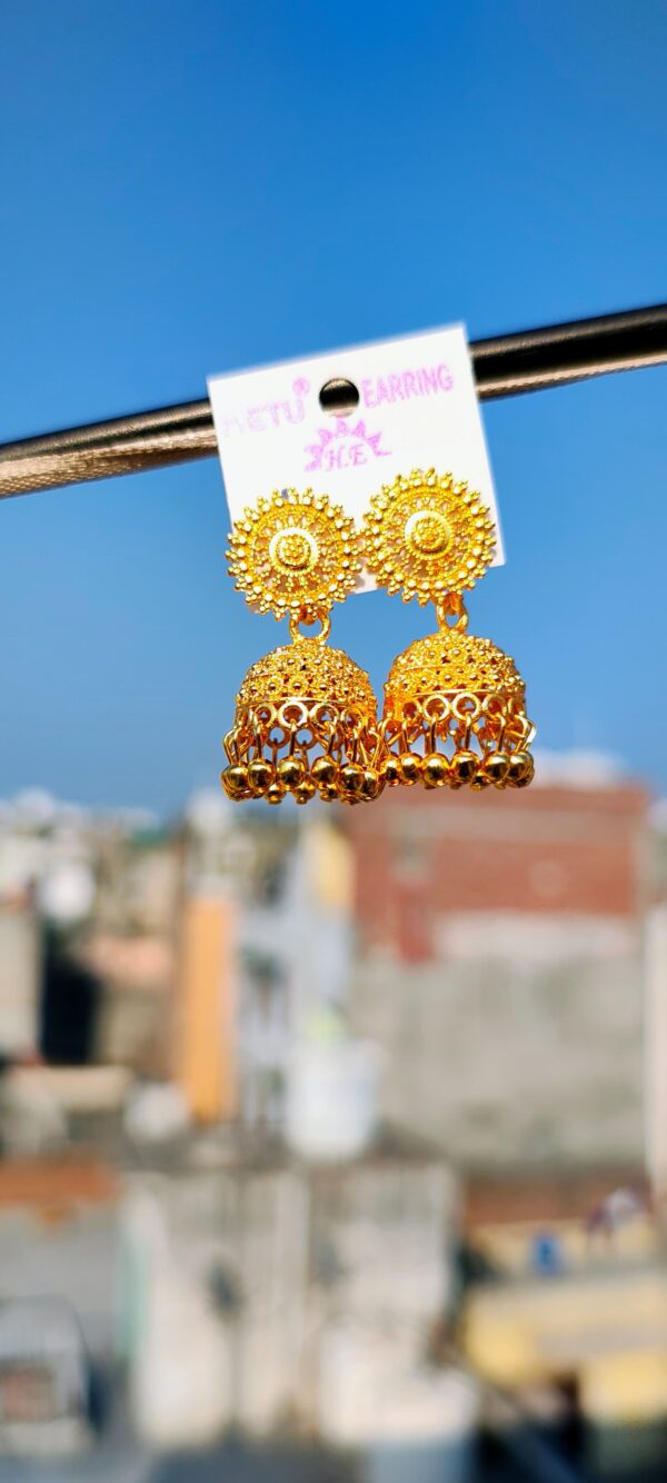 Gold-toned jhumka earrings with intricate designs.