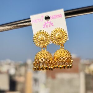 Gold-toned jhumka earrings with intricate designs.