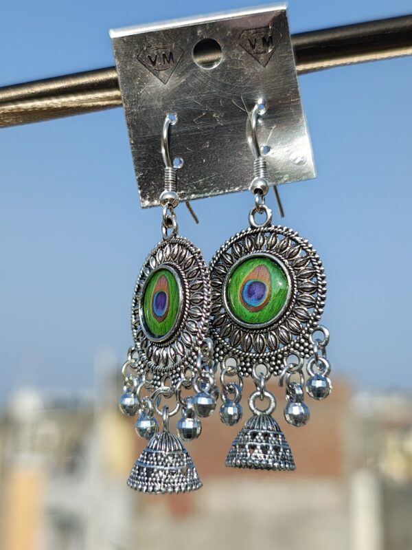 Oxidized silver earrings with a peacock feather design.