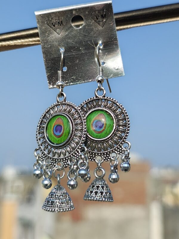 Oxidized silver earrings with a peacock feather design.