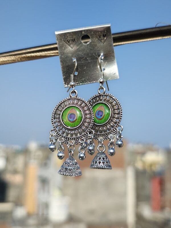 Oxidized silver earrings with a peacock feather design.