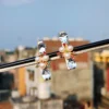 Gold-tone crystal pearl hair clip with teardrop crystals, pearls, and colorful gemstones, elegantly designed for a stylish look.