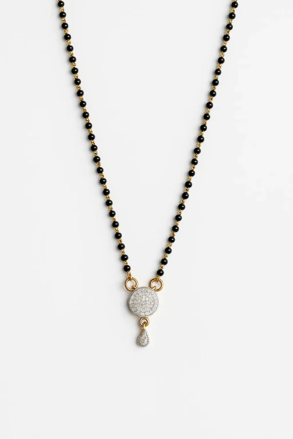 Artificial diamond mangalsutra with black and gold beaded chain and circular pendant design.