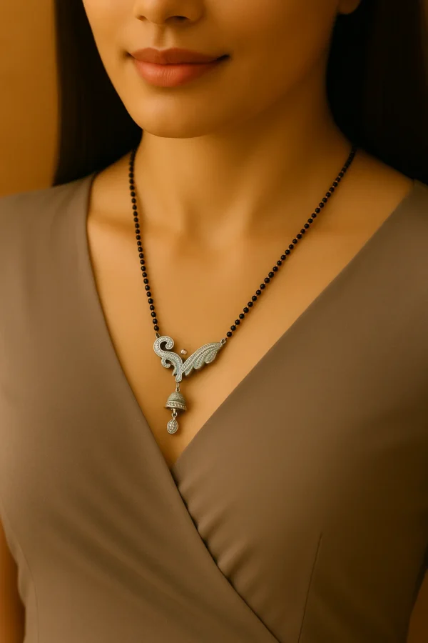 Close-up of a woman wearing a designer mangalsutra with a silver pendant, styled with a modern V-neck brown Western dress.