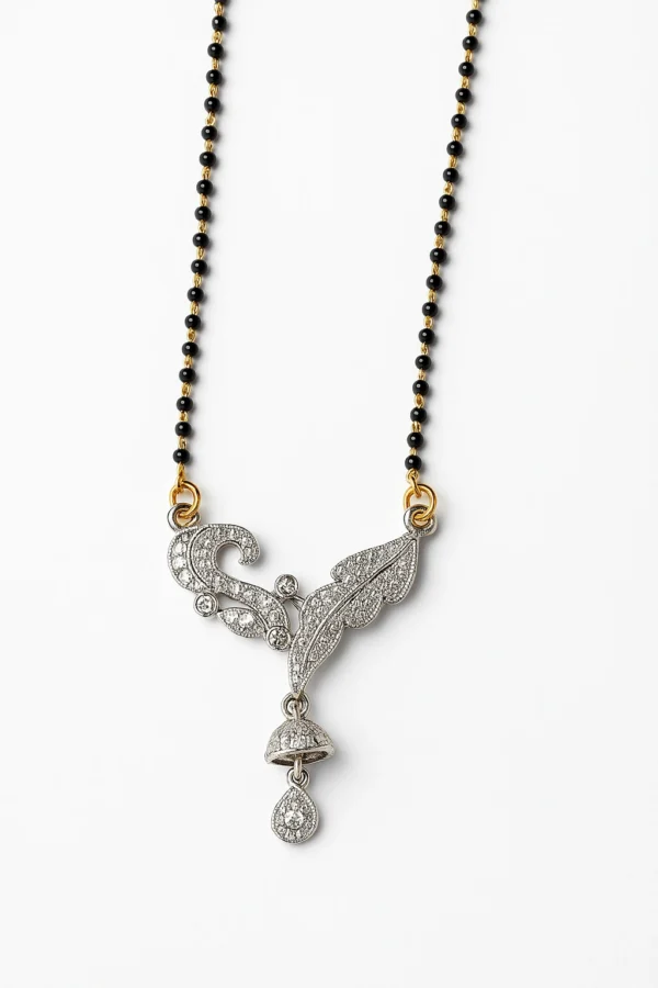 Leaf and jhumka design artificial mangalsutra displayed on a white background, showing a black and gold beaded chain with a detailed silver-toned pendant design for Dams Collections brand.