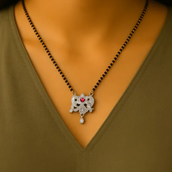 Woman wearing a floral mangalsutra with pink stone and dual peacock design