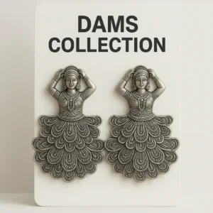 A pair of oxidized silver earrings in a traditional Indian dancer design displayed on a DAMS Collection card.