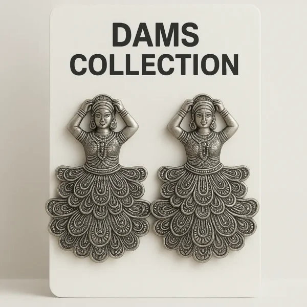 A pair of oxidized silver earrings in a traditional Indian dancer design displayed on a DAMS Collection card.