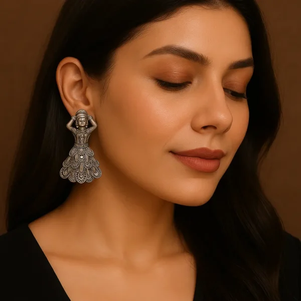 Close-up portrait of a woman wearing oxidized dancer motif earrings from DAMS Collection, styled with a black outfit and minimal makeup, showcasing traditional artificial jewellery in a modern look.