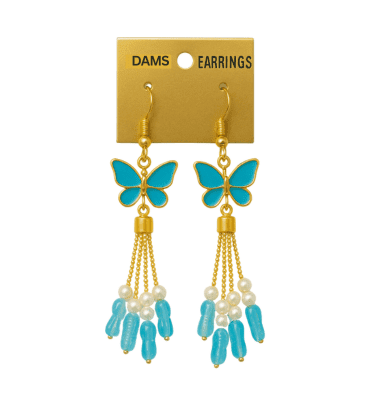 Close-up of stylish blue butterfly earrings with pearl, hanging outdoors on a display card.